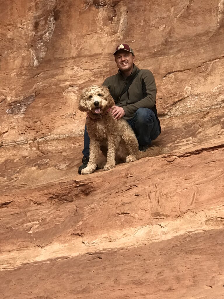 Matt Halvorson hiking with his red golden doodle 